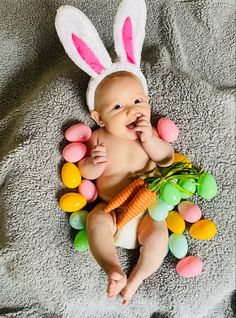 First Easter Photoshoot. Baby in a pile of eggs with bunny ears on. Easter Photoshoot Baby 3 Months, Diy Newborn Easter Pictures At Home, Diy First Easter Pictures, Diy Easter Baby Photos, Newborn Easter Pictures At Home, Easter Boy Photoshoot, Diy Newborn Easter Pictures, Easter Infant Photoshoot, At Home Easter Photoshoot Baby