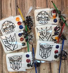 decorated cookies in the shape of transformer logos are on display for children to enjoy