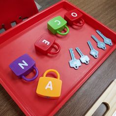 a red tray with letters and keys on it