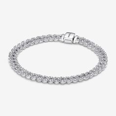 Elevate your look with the Pandora Timeless Pavé Cuban Chain Bracelet. This sterling silver bracelet features sparkling links in a chain. The top of each half circle is set with three round stones, while the back of the chain is polished for shine and comfort. The bracelet closes with a flat, square-shaped clasp featuring an engraved Pandora logo. Combining the linear geometry of our iconic chains with sparkling pavé, this sterling silver chain bracelet is a forever piece with of-the-moment appe Elegant Cuban Link Chain Bracelet With Diamond Cut, Elegant Sterling Silver Cuban Link Bracelet For Formal, Elegant Diamond Cut Cuban Link Chain Bracelet, Elegant Cuban Link Diamond Cut Bracelets, White Gold Jubilee Chain Link Bracelet, Diamond Cuban Link Jubilee Bracelet In White Gold, Classic Cubic Zirconia Bracelet With Solid Link, Elegant Cuban Link Bracelet With Silver Chain For Formal, Elegant Silver Cuban Link Bracelet