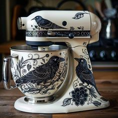 a white mixer with black birds painted on it