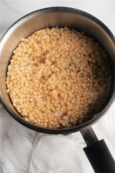 a pan filled with brown rice sitting on top of a table