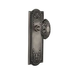 an antique style door handle with ornate design