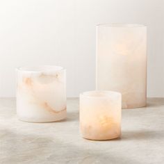 three marbled candles sitting on top of a table