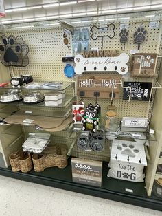 a display case filled with lots of items in a pet store's front window