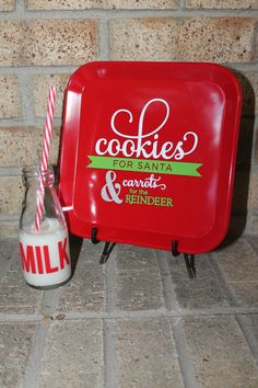 a red cookie box sitting next to a bottle of milk