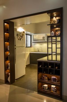 an open door leading to a kitchen and dining area with coffee mugs on shelves