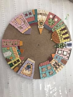 a circular piece of art made out of colorful tiles