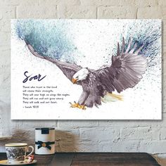 an eagle with the words soar on it and water splashing from its wings