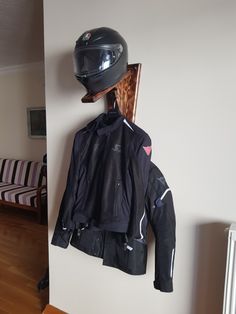 a motorcycle jacket and helmet hanging on the wall