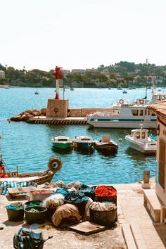 there are many boats in the water and one boat is parked on the dock next to it