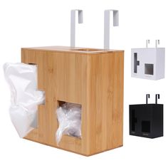 a wooden box with two tissue dispensers in it and some plastic bags