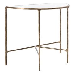 an oval glass table with gold metal legs