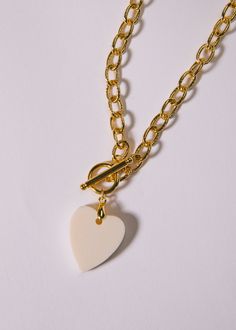 16" gold-filled link chain attached with dangling white bone heart. Elegant White Heart Necklace With Chain, Chunky Chain White Necklace For Everyday Wear, White Chunky Chain Necklace For Everyday, Everyday White Chunky Chain Necklace, White Heart-shaped Jewelry With Adjustable Chain, White Chunky Chain Jewelry For Everyday, Everyday White Jewelry With Chunky Chain, Everyday White Chunky Chain Jewelry, White Heart Pendant Charm Necklace With Adjustable Chain