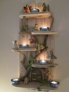 a shelf with candles and figurines on it