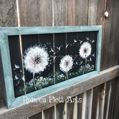 two dandelions on a black and white background are framed in an old window