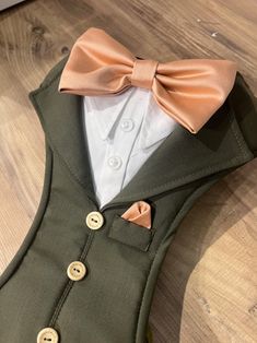 a vest with a bow tie and buttons on it