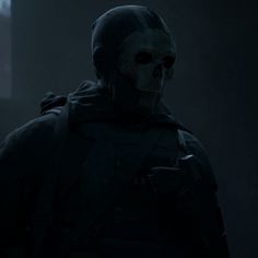 a man in a dark room wearing a mask