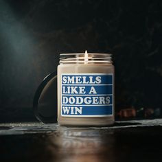 a candle that says smells like a dodger's win sitting on a table