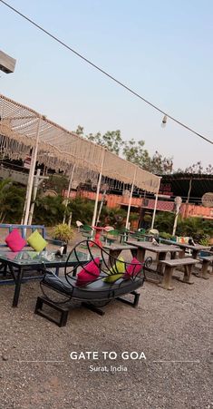 an outdoor seating area with tables and chairs