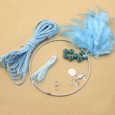 some beads and feathers are on a table