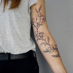 a woman with a flower tattoo on her arm