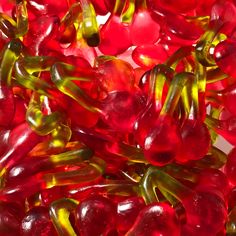 some red and yellow gummy bears are in a pile