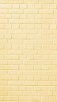 a red fire hydrant sitting in front of a yellow brick wall