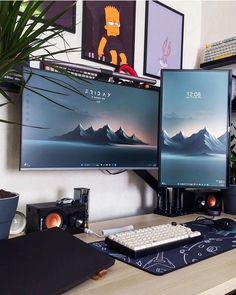 two computer monitors sitting on top of a wooden desk