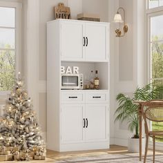 a christmas tree in the corner of a room with white cabinets and lights on it