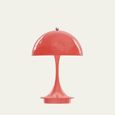 a red table lamp on a white background