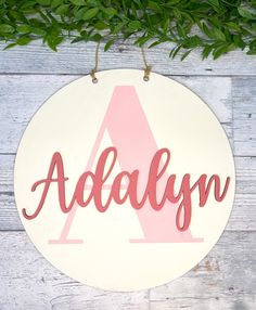 a wooden sign with the word addalyn hanging from it's side on a wall