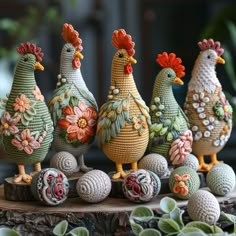 four chickens are sitting on top of some balls and flowers in front of them is a potted plant