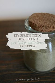 a jar filled with dirt sitting on top of a wooden table next to a sign