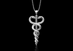 This ancient Greek symbol is found everywhere in the world today. It was a staff that belonged to the Greek god of medicine, Asclepius. Hospitals and health organizations use it as a logo, but you can wear it as a necklace to show your pride and/or support for the medical and health industry. It's a great gift for: doctors, nurses, members of the healthcare profession, herpetologists, ancient Greek experts, starry-eyed pre-med students. Silver production requires 15~17 business days. Please keep Snake Totem, Twin Snakes, God Of Medicine, Ancient Greek Symbols, Rod Of Asclepius, Greek Symbol, Or Nurse, Medical Symbols, Pre Med