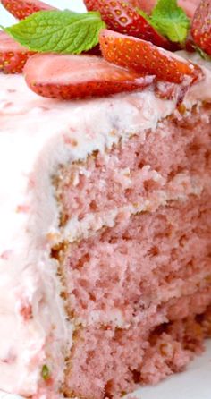 a close up of a slice of cake with strawberries on the top of it