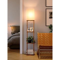 a lamp that is sitting on top of a shelf next to a chair in a room