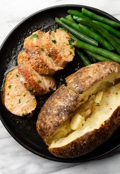 some meat and potatoes on a plate with green beans