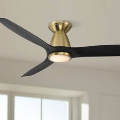 a ceiling fan with a light on top of it in a living room or bedroom