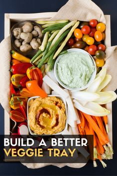 a tray filled with veggies and dips