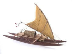 a wooden model of a boat with sails