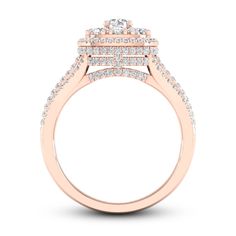 a rose gold engagement ring with two rows of diamonds on the band and an oval shaped center