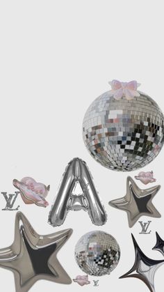 an assortment of silver and black foil balloons with bows, stars and confetti