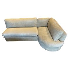 a large sectional couch sitting on top of a white floor