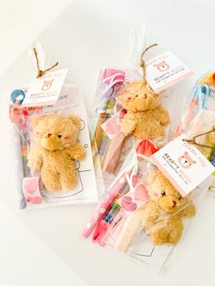 three teddy bears are packaged in cellophane and tied with twine for decoration