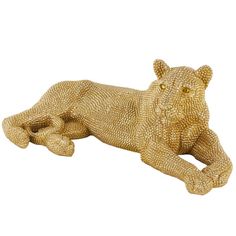 a gold colored statue of a lying tiger