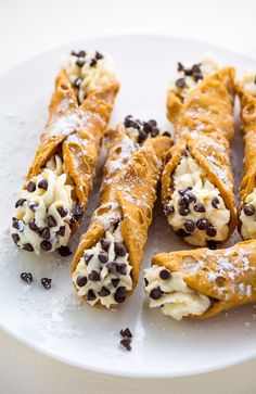 chocolate chip crepes with cream and chocolate chips on top are ready to be eaten