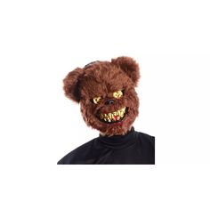 a man wearing a brown teddy bear mask with yellow eyes and fangs on his face