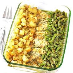 a casserole dish with potatoes, green beans and other food items in it