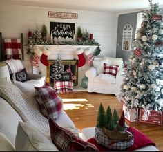 a living room decorated for christmas with red and white decorations